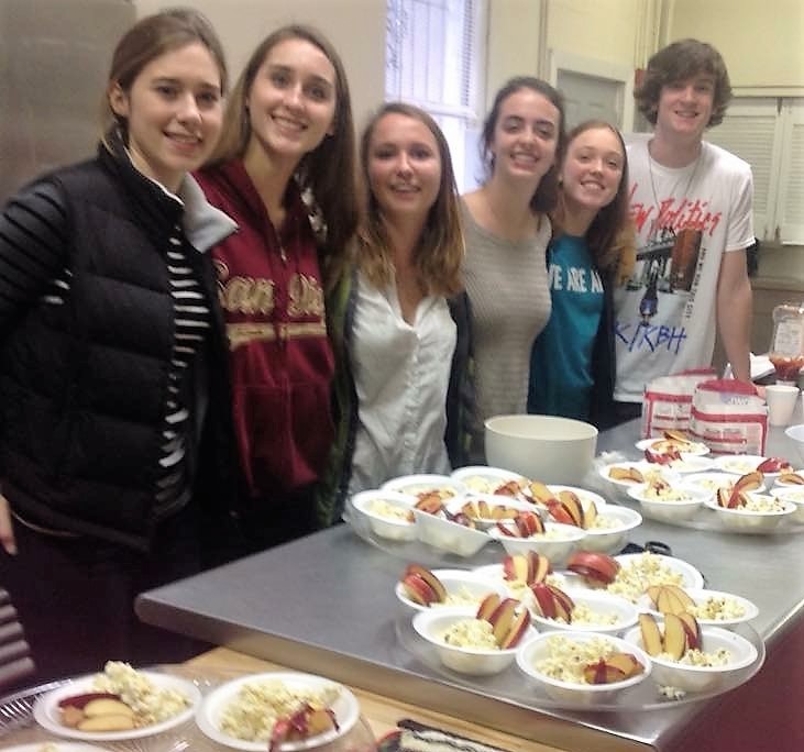 Teens helping serve food.