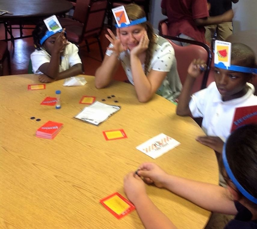 Teen playing a game with students.