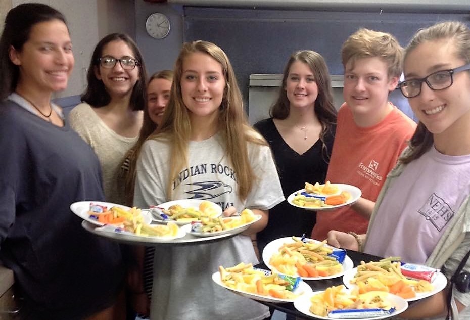 Teens serving food.