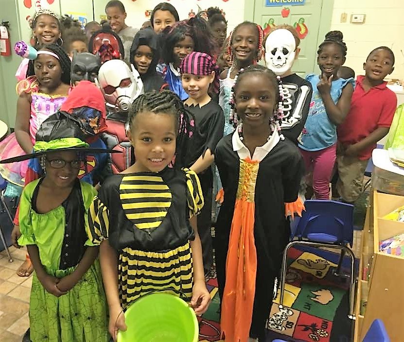 Group of students posing in halloween costumes.