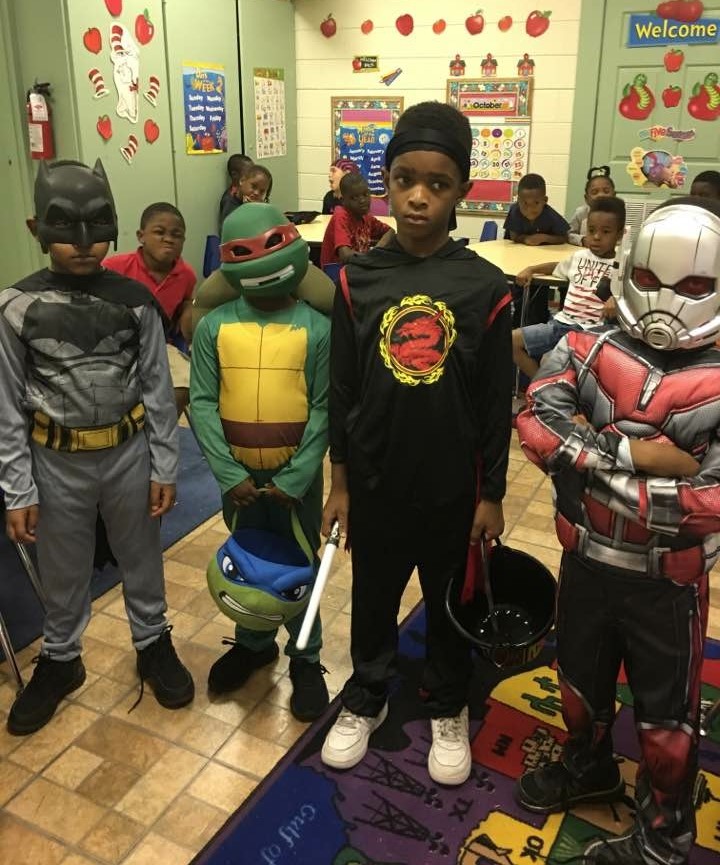 Group of students posing in halloween costumes.