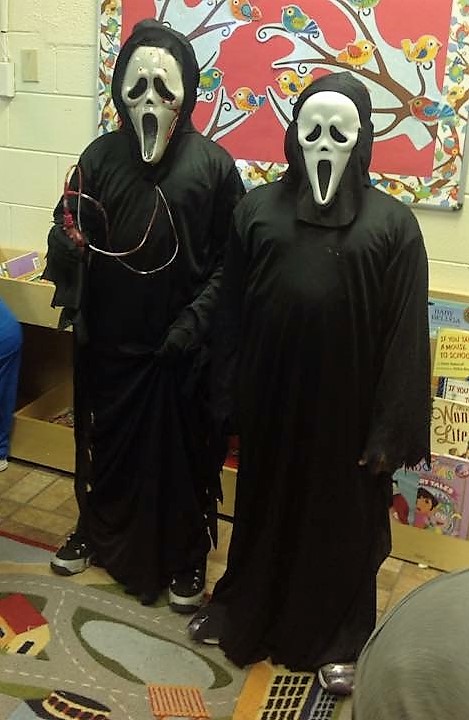 Two students posing in halloween costumes.