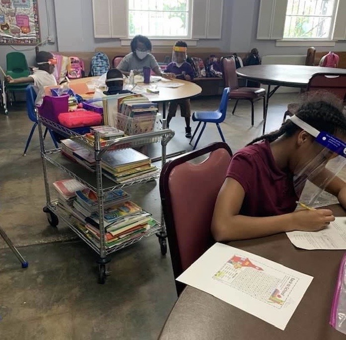 Students and teachers class in face shields and masks.